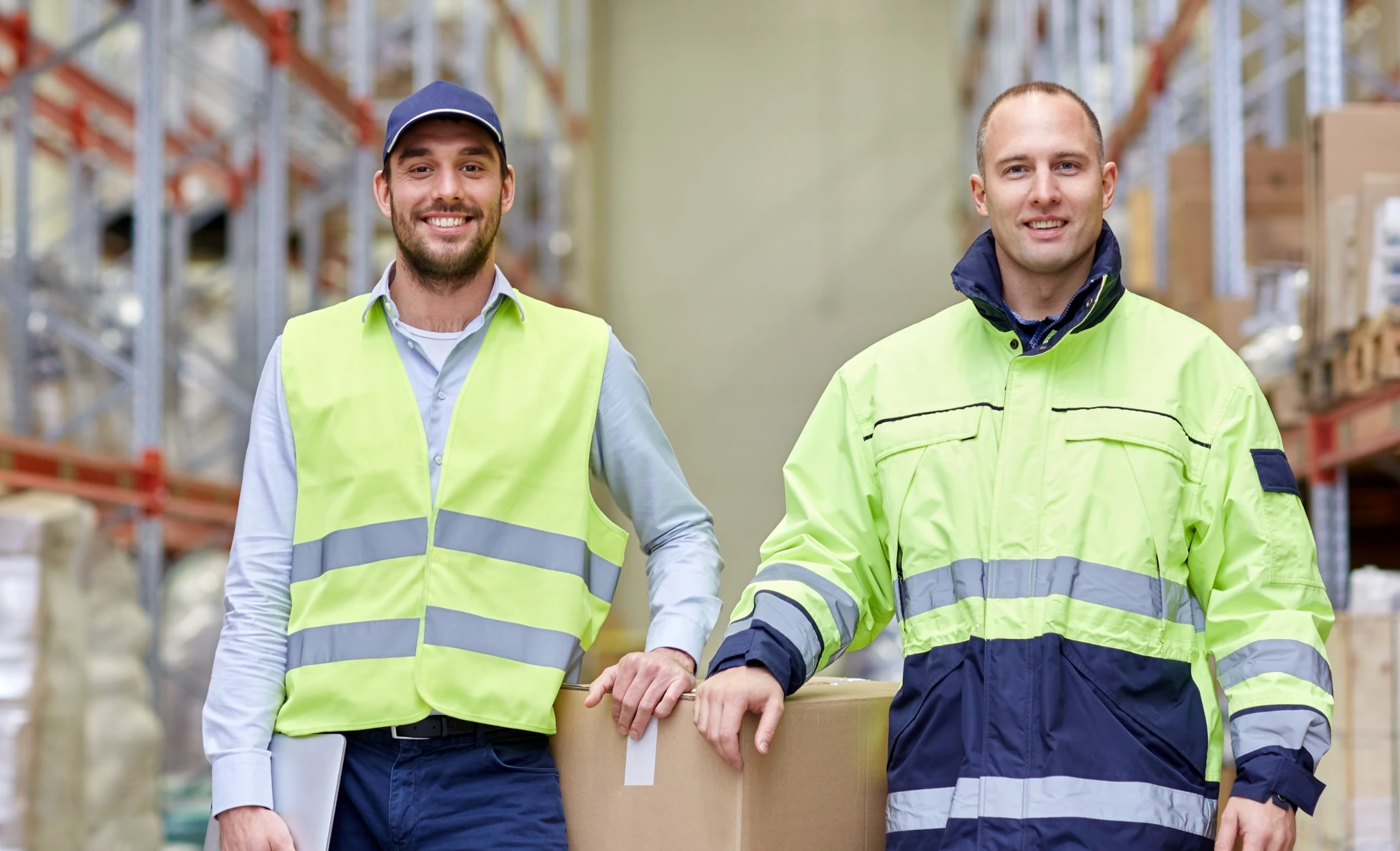 men_in_uniform_with_boxes_at_warehouse